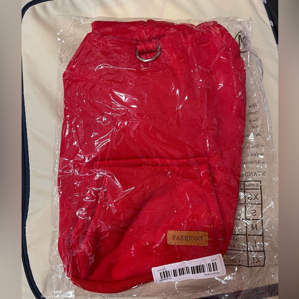 Super cute, medium sized red sweatshirt with leash clip for small dog has a hood